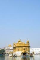 Amritsar, India - May 31 2023 - Beautiful view of Golden Temple - Harmandir Sahib in Amritsar, Punjab, India, Famous indian sikh landmark, Golden Temple, the main sanctuary of Sikhs in Amritsar, India photo