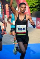 New Delhi, India - July 16 2023 - Vedanta Delhi Half Marathon race after covid in which marathon participants about to cross the finish line, Delhi Half Marathon 2022 photo