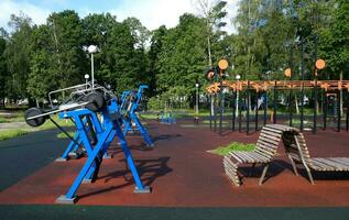 Urban sports ground with weight training and exercise equipment for sports. Sports and recreation area. Empty sports ground outdoor workout in a park. photo