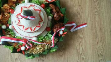 Cone Shaped Rice with Indonesian National Ribbon called Nasi Tumpeng Merah Putih For Independence Day Celebration at 17 August photo