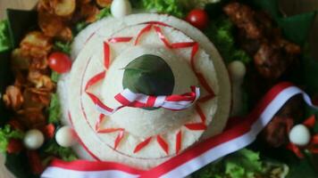 Cone Shaped Rice with Indonesian National Ribbon called Nasi Tumpeng Merah Putih For Independence Day Celebration at 17 August photo