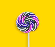 Colorful lollipops on yellow background photo