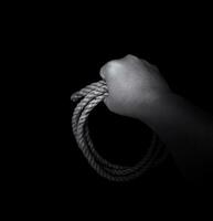 Man's hand holding on to the rope. Hand holding a rope photo