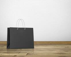 black paper bag in room white walls and wooden floor photo