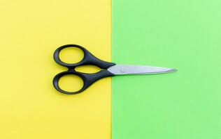 Scissors placed on colored papers, after some edits. photo