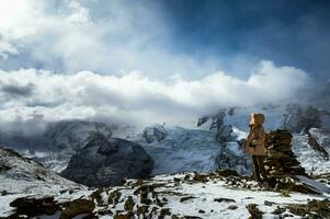 An impressive scene of a man in winter coat admiring the beauty and majesty of the Matterhorn, one of Switzerland's highest peaks photo