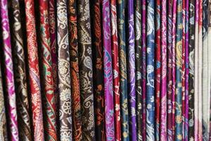 Oriental, Turkish, Indian multi-colored women's silk headscarves handmade on shop window for sale. photo