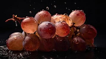 Grape fruits hit by splashes of water with black blur background, photo