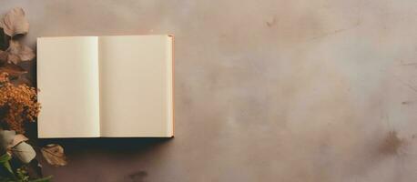 Photo of an open book and vase of flowers on a table with copy space