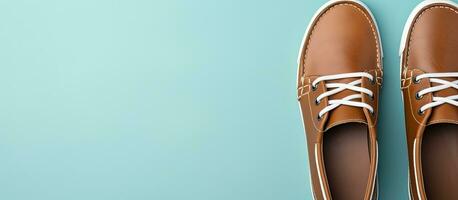 Photo of a pair of stylish brown shoes with white laces on a clean background with copy space