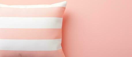 Photo of a pink and white striped pillow against a pink wall with space for text or design with copy space