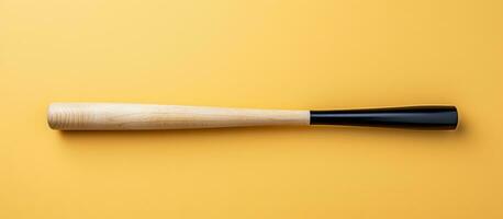 Photo of a black and white baseball bat on a vibrant yellow background with copy space