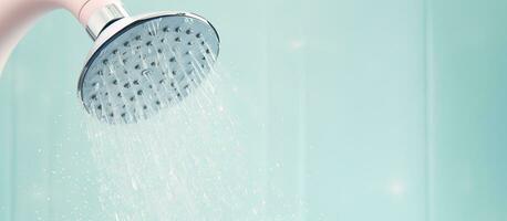 Photo of a shower head with water flowing with copy space