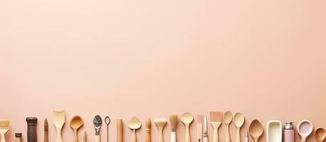 Photo of a row of spoons lined up against a pink wall with empty space for text or design with copy space