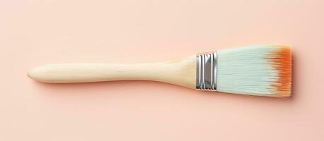 Photo of a paint brush on a pink background with plenty of empty space for text or design elements with copy space