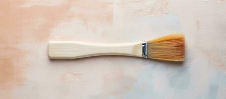 Photo of a paint brush resting on a table, ready for the artists next stroke with copy space