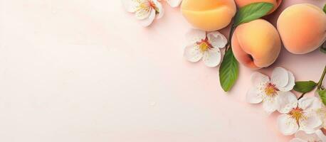 Photo of peaches with leaves and flowers on a pink background with copy space