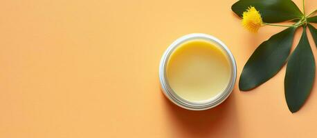 Photo of a cup of yellow liquid next to a vibrant plant with plenty of copy space with copy space