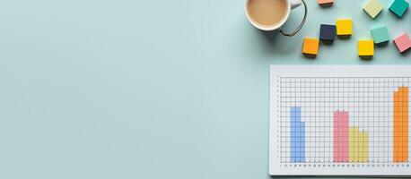 Photo of a cup of coffee next to a paper with a graph on it, with plenty of space for your own notes or ideas with copy space