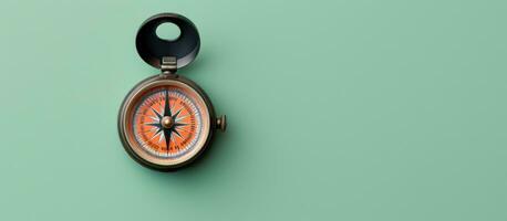 Photo of a compass on a green wall with a black handle, with copy space with copy space