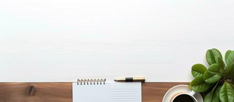Photo of a neatly organized desk with essential work tools and a steaming cup of coffee with copy space