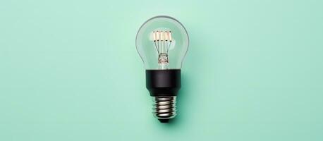 Photo of a glowing light bulb on a vibrant green background with copy space with copy space