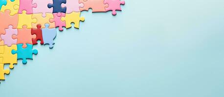 Photo of colorful puzzle pieces on a vibrant blue background with plenty of copy space with copy space