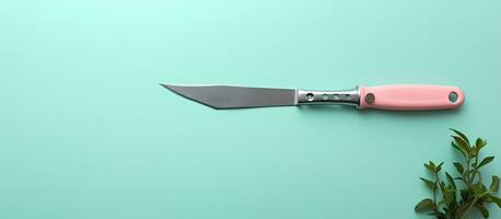 Photo of a pink and black knife on a table with empty space for text or design with copy space