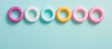 Photo of a pair of blue and white rings on a pink background with copy space with copy space