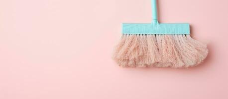 Photo of a colorful dust brush hanging on a vibrant pink wall with plenty of copy space with copy space