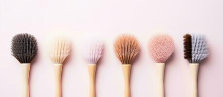 Photo of five brushes on a vibrant pink background, ready for creativity with copy space