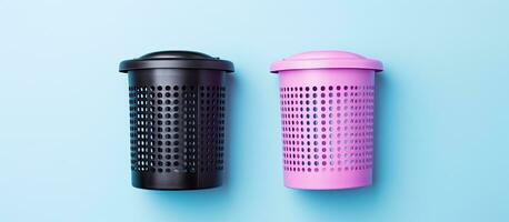 Photo of two black and pink trash cans on a blue background with plenty of empty space for text or design elements with copy space