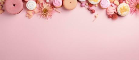 Photo of colorful candies on a pink background with space for text or design with copy space