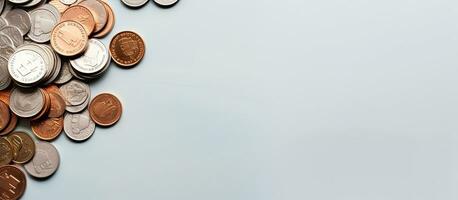 Photo of a stack of coins on a wooden table with empty space for text or design with copy space