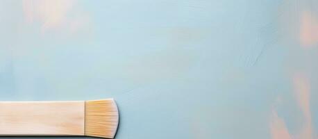 Photo of a paint brush with white bristles, ready for artistic creation with copy space