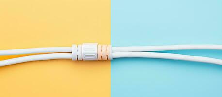 Photo of a white cord connected to a yellow and blue wall with copy space with copy space