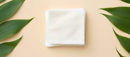 Photo of a white napkin with green leaves on a table, offering a blank space for your creative ideas with copy space