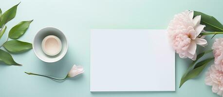 Photo of pink flowers and a cup of coffee on a blue background with copy space with copy space