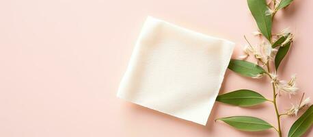 Photo of a flower and a piece of paper on a pink background with copy space with copy space