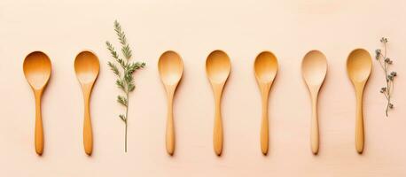 Photo of a row of wooden spoons on a white background with copy space