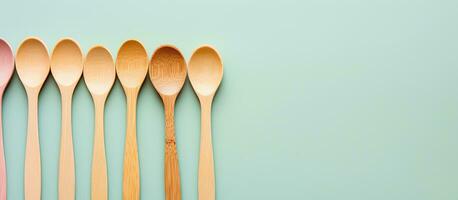 Photo of a row of wooden spoons against a vibrant blue background with copy space