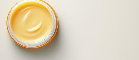 Photo of a jar of cream on a clean white table with plenty of space for text or other elements with copy space