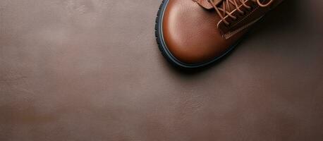 Photo of a pair of brown shoes on a wooden floor with empty space for text or design with copy space