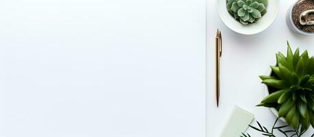 Photo of a minimalistic desk with a white sheet of paper, a plant, and a pair of scissors with copy space