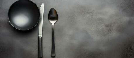 Photo of a table setting with a spoon, knife, and spoon rest with copy space