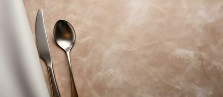 Photo of a spoon and knife on a table with empty space for copy with copy space