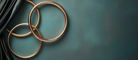 Photo of two gold rings hanging elegantly from a curtain, creating a stunning visual effect with copy space