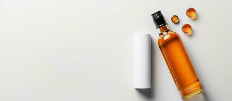 Photo of a bottle of oil and pills on a white background with copy space