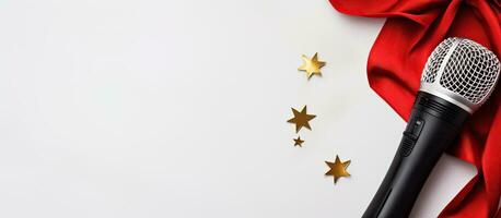 Photo of a microphone on a vibrant red cloth adorned with shimmering gold stars with copy space