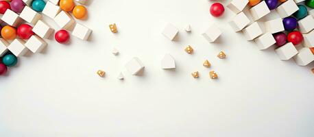 Photo of colorful candies scattered on a white surface with plenty of copy space with copy space